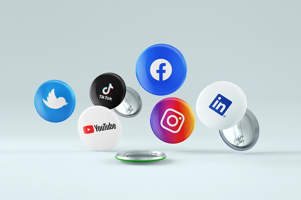 Various social media logo pins including Facebook, Instagram, Twitter, LinkedIn, YouTube, and TikTok, representing social media management.