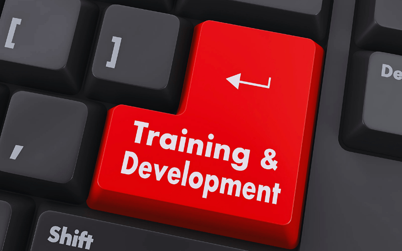 A red keyboard key labeled "Training & Development" indicating virtual assistant skill enhancement.