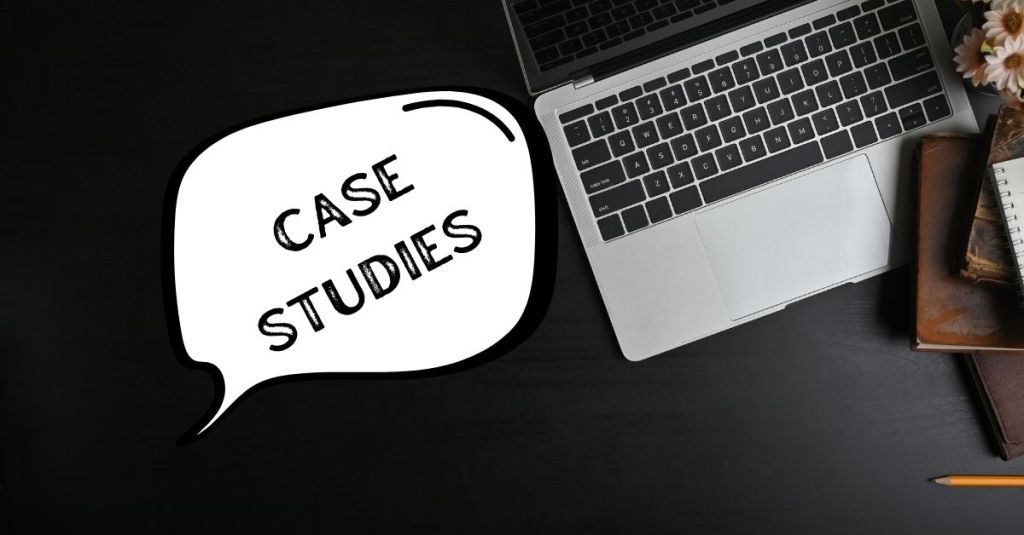An overhead shot of a laptop, books, and a pencil with a speech bubble containing the words "CASE STUDIES.