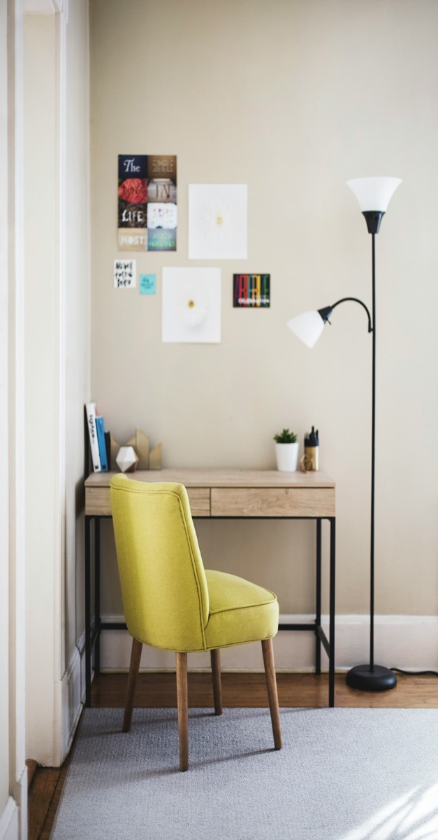 Cozy budget-friendly home office setup with a green chair and minimalist desk